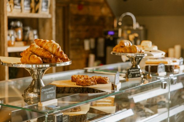 A deli counter with pastries, cakes and other homemade treats