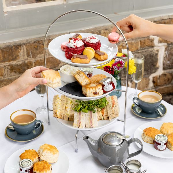 Afternoon tea selection of cakes, finger sandwiches and sweet treats.